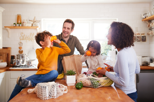 Family playing with food in a kitchen